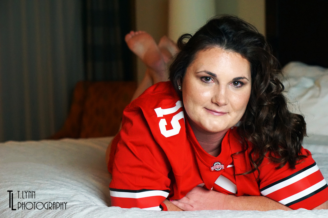 Picture of woman laying on bed in sports jersey